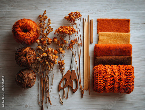 - Knitting supplies on flat lay in orange tones for crafts