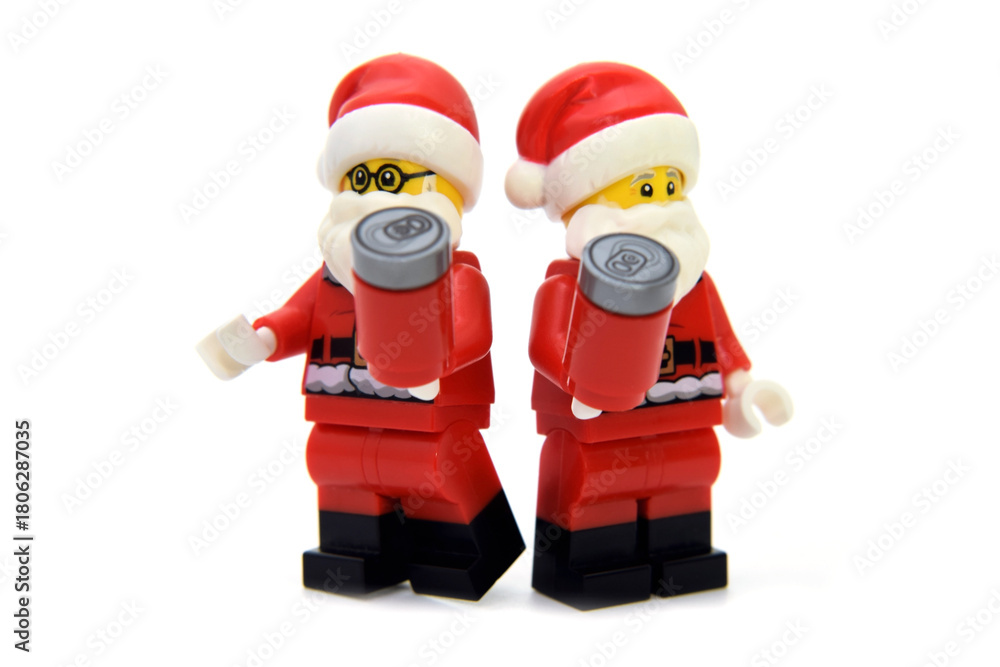 Naklejka premium Editorial illustrative image of lego minifigure of two Santa Claus with Cola cans isolated on white.