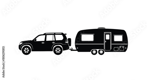 Black silhouette of an suv towing a small rounded travel trailer