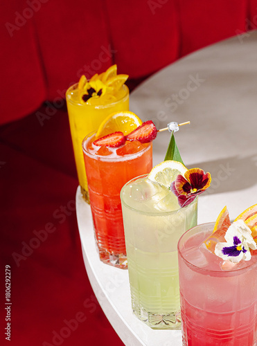 Colorful cocktails on a table in a vibrant bar during a lively evening
