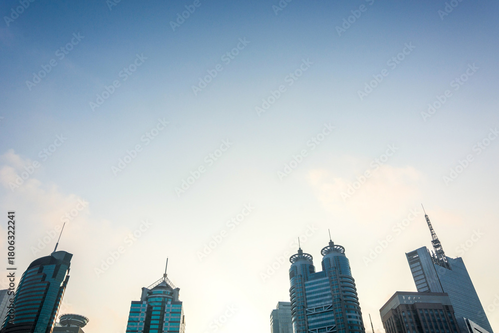 Fototapeta premium Modern city skyline with tall buildings under blue sky