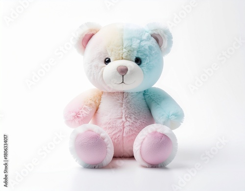 A pastel, fluffy teddy bear sitting upright