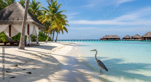 Fototapeta Naklejka Na Ścianę i Meble -  Exotic beach with heron, palm trees, cabana, and luxury resort.