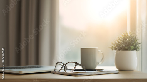 Serene Workspace with Warm Ambiance: A minimalist desk scene unfolds by a sunlit window. The setup invites tranquility, perfect for work or contemplation.