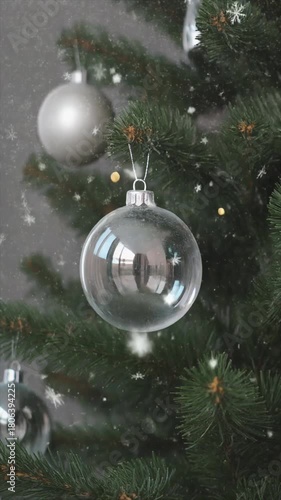 Silver baubles on a green christmas tree suitable for holiday greeting cards, festive social media posts, winterthemed website banners.