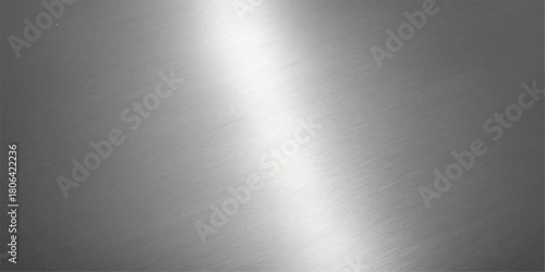Brushed stainless steel metal surface with a shiny metallic texture and light reflection on an industrial aluminum backdrop