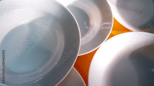 White plate top view with shadows during daytime. Abstract texture background of white plate. Ceramic, clean, minimal, luxury, artisan, still-life, natural light concept for background, texture, print