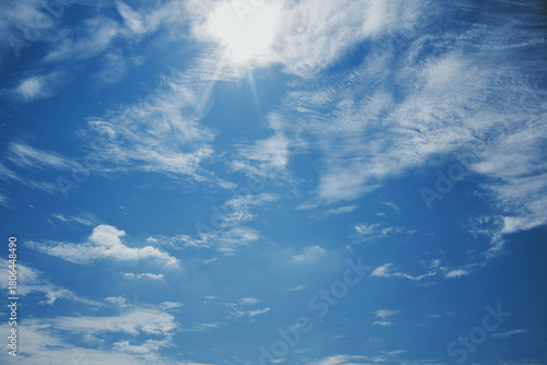 The blue sky with the bright sunlight looks like the sun shining on the ocean surface.