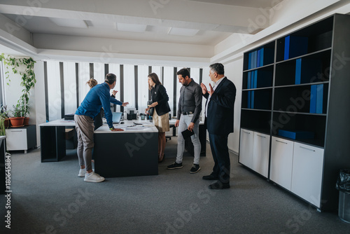 Obraz na płótnie Business team gathered in a modern office, engaging in discussions and teamwork
