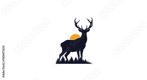 Majestic black silhouette of a stag with large antlers standing in a pine forest with an orange sun rising in the background.