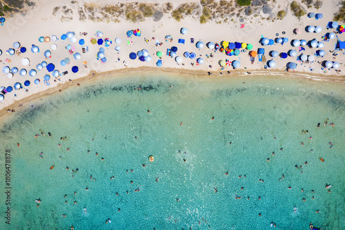 Fototapeta Naklejka Na Ścianę i Meble -  Aerial overhead view of a crowded beach with turquoise sea as seen in Messinia, Greece, during summer time