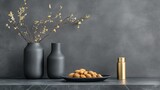 A modern still life composition featuring elegant black vases, delicate branches, and a plate of nuts, perfect for home decor, lifestyle blogs, and culinary presentations,