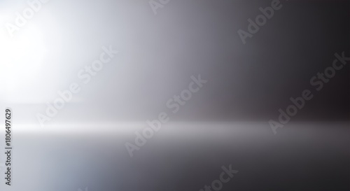 Abstract gradient background with a bright light source and a reflective surface.