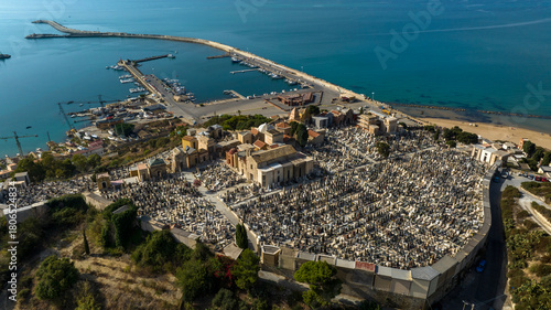 Aerial view of the cemetery of Licata, in the province of Agrigento, Sicily, Italy. It is a small Catholic cemetery overlooking the harbor on the Mediterranean Sea.