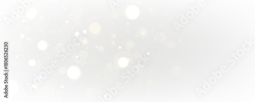 White sparks and stars glitter with soft golden glow on a transparent background. Magical sparkling dust particles create an elegant festive design for Christmas and winter holidays.