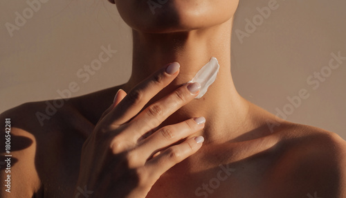 Wallpaper Mural Minimalist skincare scene with hand gently applying soothing cream to neck area, soft warm lighting, healthy skin, self care, relaxation, and beauty routine Torontodigital.ca