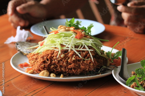 Crispy fried fish with green papaya salad, Thai food
