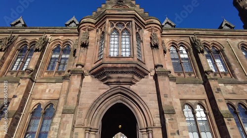 Glasgow Scotland: 8th Jan 2025: University of Glasgow Gilmorehill. Historical architecture of a university building under a clear blue sky in Glasgow during the daytime