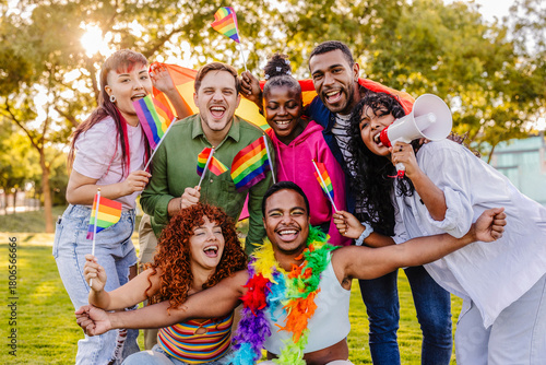 Diverse group celebrating lgbtq plus pride with rainbow flags