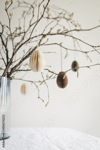 Quadro su tela Easter paper eggs hanging on branches. Easter decor.
