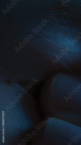 Close-up of a tired eye of a man wearing eyeglasses who takes off his glasses and rubs his eyes from fatigue after long computer screen time or doomscrolling. Eye strain, overwork, and vision problems