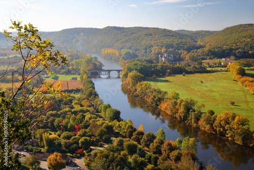 The countryside and the river Dordogne viewed from the top of the medieval village Beynac et Cazenac, Dordogne, France, with autumn colors and Feyrac Castle on the right