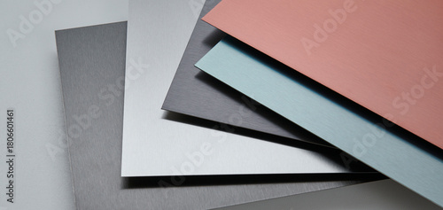 Close up image of metallic surface sheets with brushed and matte finishes, showcasing industrial texture and modern material design for architecture, manufacturing, and product design applications.