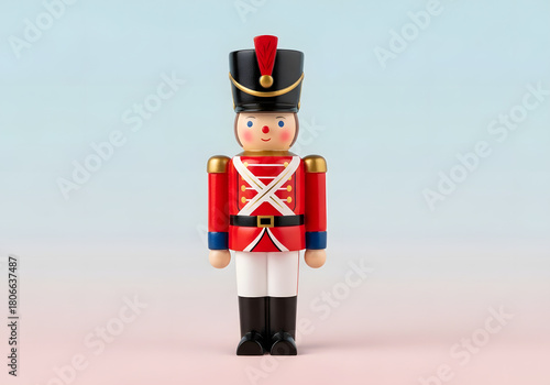 Miniature toy soldier nutcracker figure in red blue white uniform standing upright against background