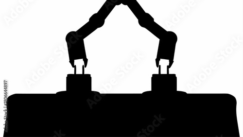 Silhouette of two robotic arms reaching down to touch something on a dark surface in a factory setting
