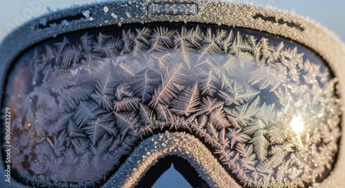 Macro shot of explorer goggles with intricate frost patterns forming on the lens, light refracting through frozen lines, showcasing high-detail expedition gear against a clean isolated background.
