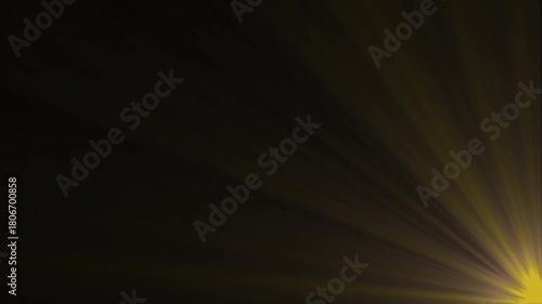 Golden sunburst rays emanating from bottom right corner dark background abstract light flare effect