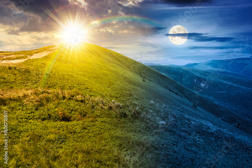 Fototapeta Naklejka Na Ścianę i Meble -  alpine meadows in mountains on summer solstice. day and night time change concept. beautiful view of rolling hills with lush green grass under sky with sun and moon. duality and transition template