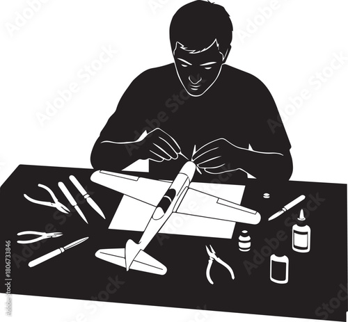 Hobbyist assembles model airplane with tools and glue on a workbench creating a detailed miniature replica