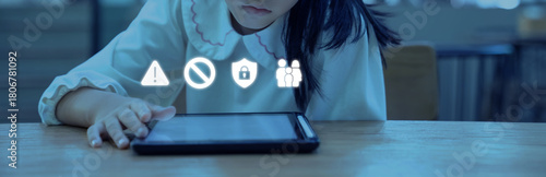 Soft blue light reflects on the tablet as the child taps the screen while safety icons appear above concerns about online risks and the need for careful guidance.