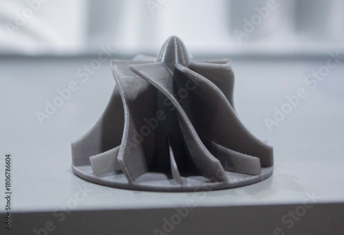 Prototype turbine compressor wheel printed on a 3D printer. Small model turbine rotor created on a 3D printer from molten plastic. 3D printing technology. New modern additive FDM printing technologies