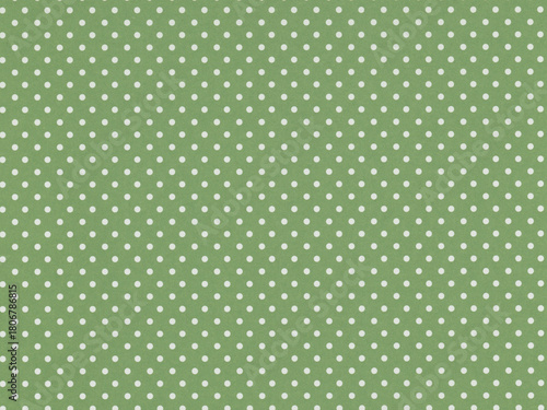 Green background with evenly spaced white polka dots. The pattern consists of small, uniform dots creating a playful design. The dots are aligned in a regular grid pattern across the entire surface.