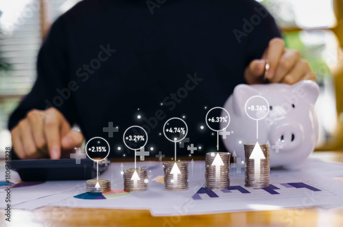 Stacks of coins with glowing growth percentages and a person calculating finances, representing investment returns, financial planning, and economic data analysis in a modern money management concept.