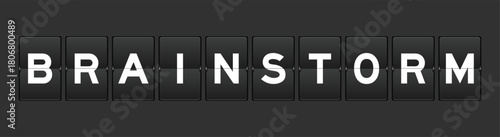 Black color analog flip board with word brainstorm on gray background