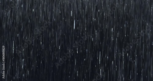 Heavy rain pours down in a dense curtain against a pure black screen, splashing close-up detail. Practical loopable rainfall footage ideal for VFX inserts, storm scenes, and dramatic atmospheres