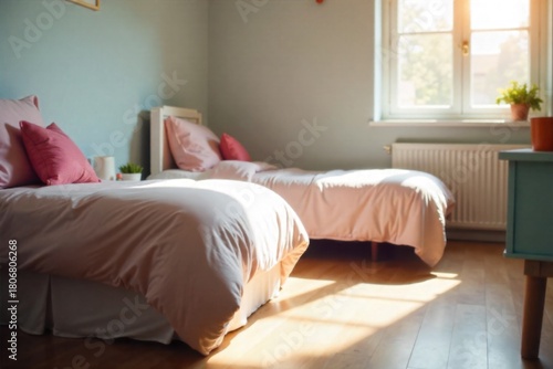 A bedroom scene with neatly made beds, toys scattered on the floor, and storybooks on the nightstand. A medium shot of a child s bedroom. Two neatly made twin beds are the focal point. On the floor, a