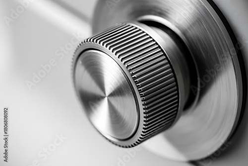 Close-up of a shiny silver metallic knurled control knob or dial mechanism