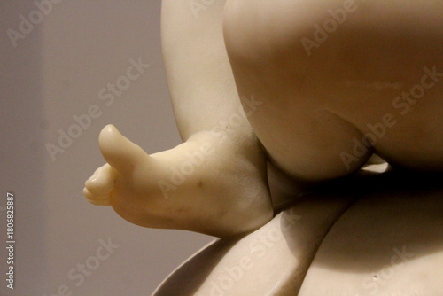 Tiny feet of a child in white marble