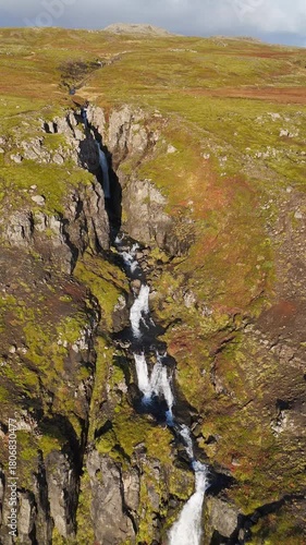 Aerial view of a waterfall on the Snaefellsnes peninsula in Iceland - vertical 4K video
