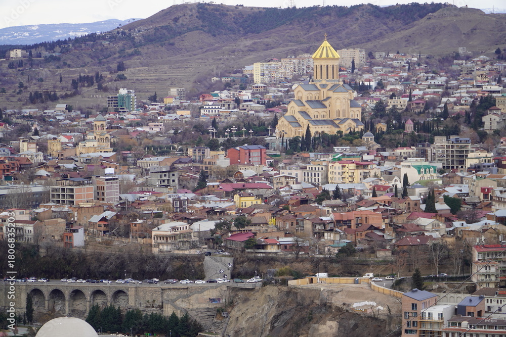 Obraz premium View of the Old Town of Tbilisi, Georgia, with the ancient Narikala fortress towering over it.