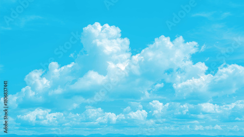 Vibrant blue sky with fluffy white cumulus clouds on a clear sunny summer day