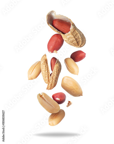 Cracked and whole peanuts flying in the air close-up on a white background