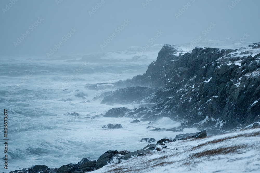 Obraz premium Rocky coastline during winter storm, icy waves crashing, snow-covered cliffs, cold dramatic atmosphere, realistic texture details