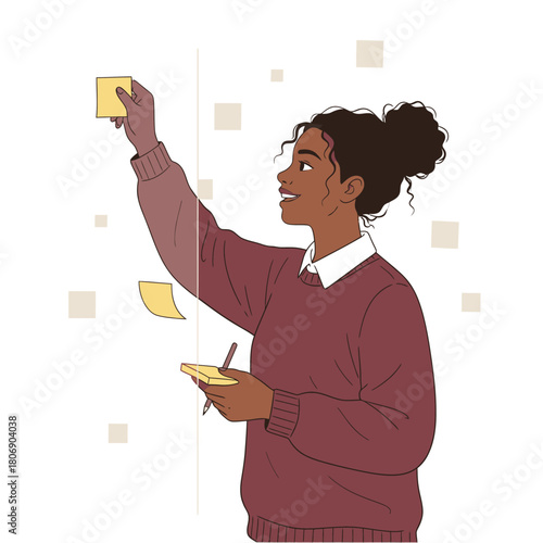 Young woman placing a yellow sticky note on a board for brainstorming and project planning