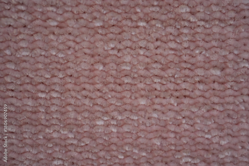 Fototapeta premium pink Soft plush fabric texture, close-up macro view of soft plush fabric with a warm, fuzzy surface. The detailed texture shows dense fibers and a gentle, velvety feel commonly used in blankets, cloth