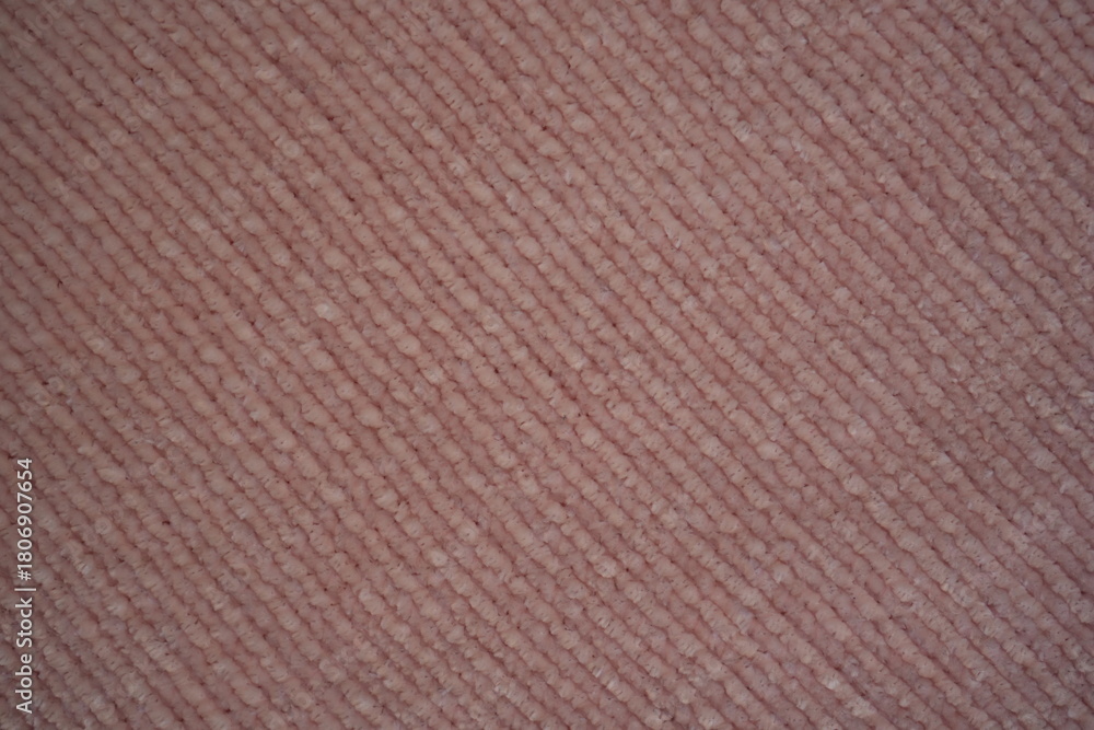 Fototapeta premium pink Soft plush fabric texture, close-up macro view of soft plush fabric with a warm, fuzzy surface. The detailed texture shows dense fibers and a gentle, velvety feel commonly used in blankets, cloth